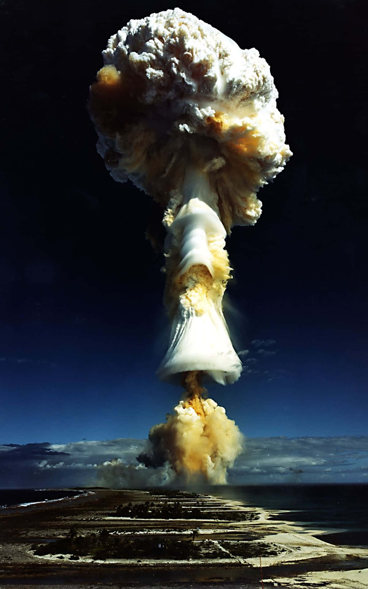 a nuclear explosion is seen over a beach Picha ya Ukuta