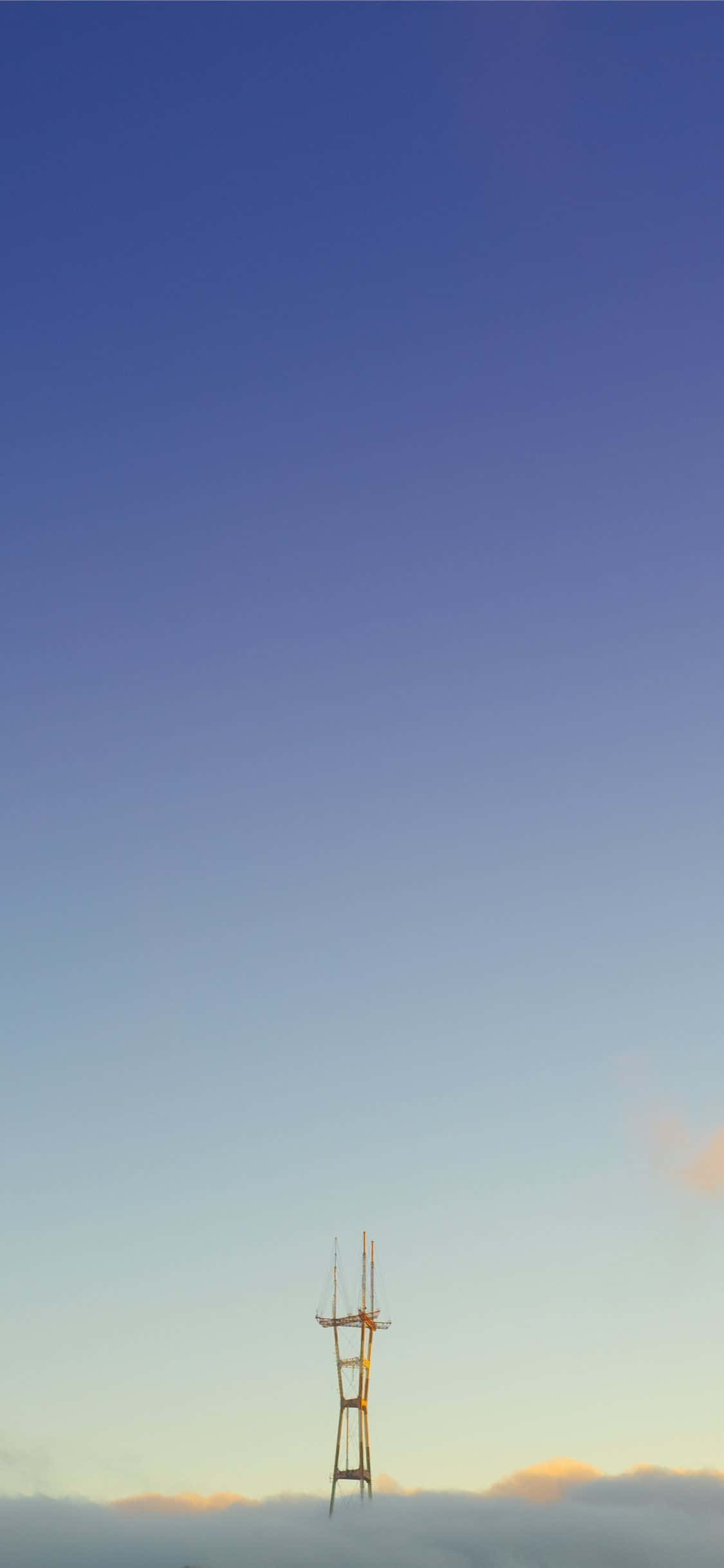 a telephone tower is standing in the fog Picha ya Ukuta