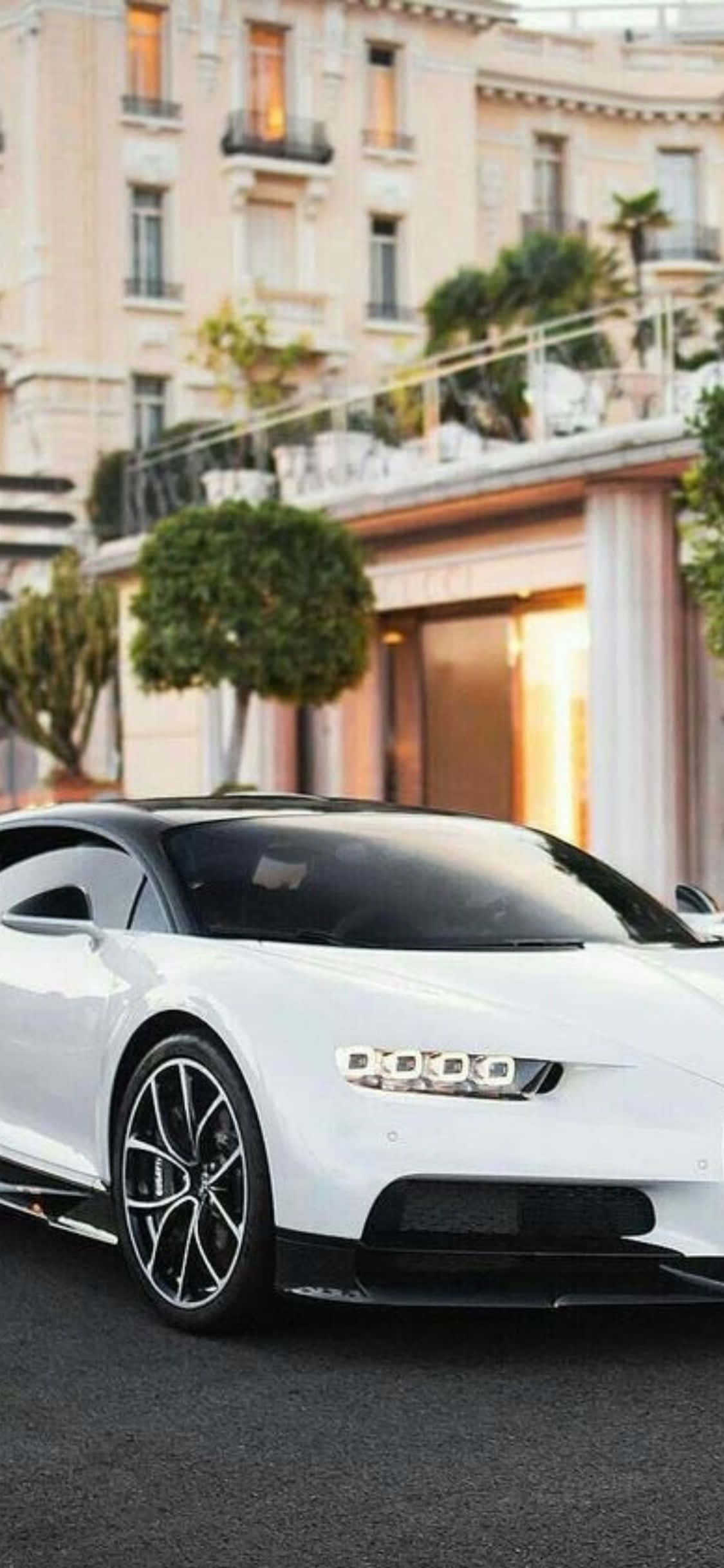 bugatti chiron nyeupe inapark mbele ya jengo Picha ya Ukuta