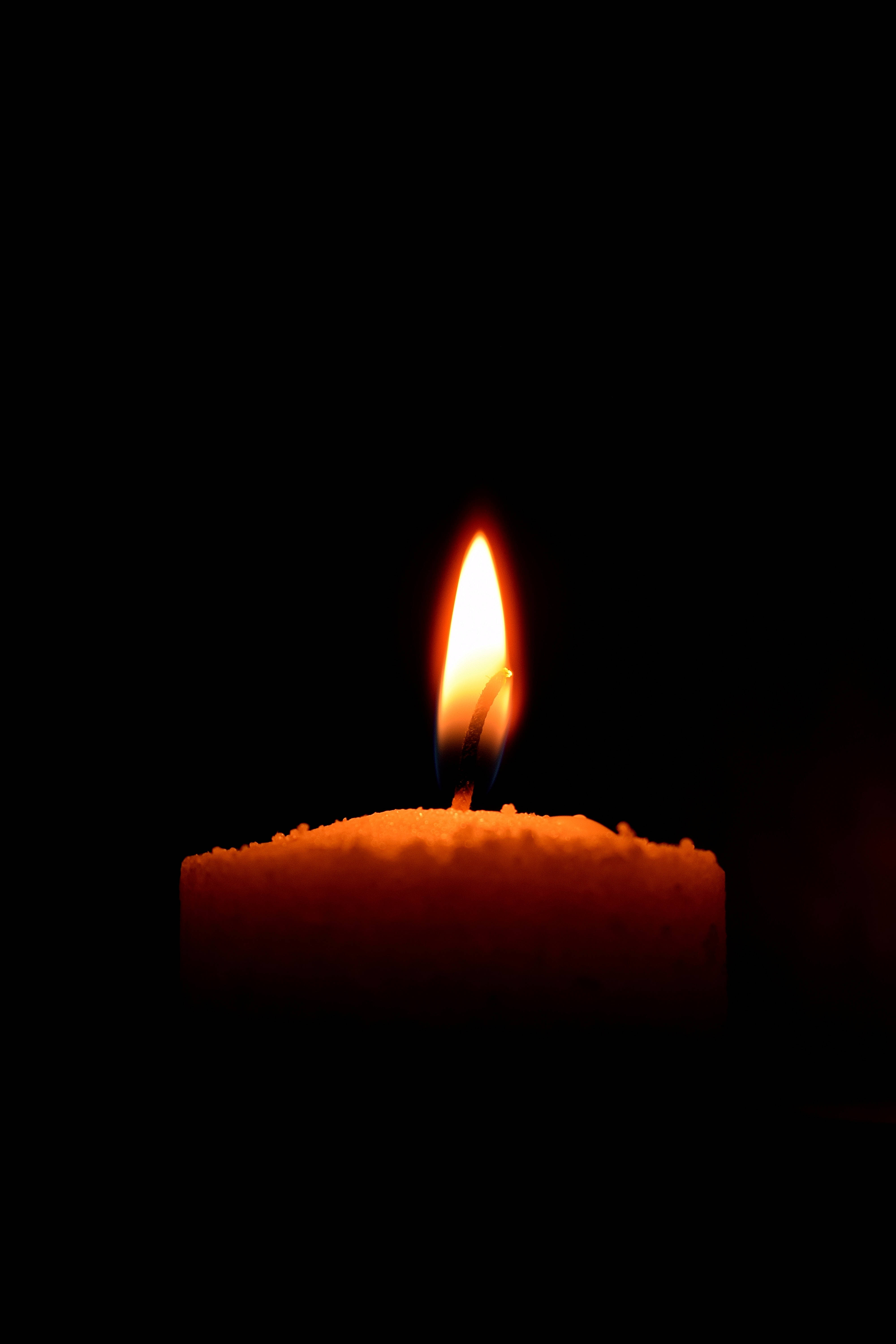 Enjoy a peaceful moment with Dim's lighted candle Picha ya Ukuta