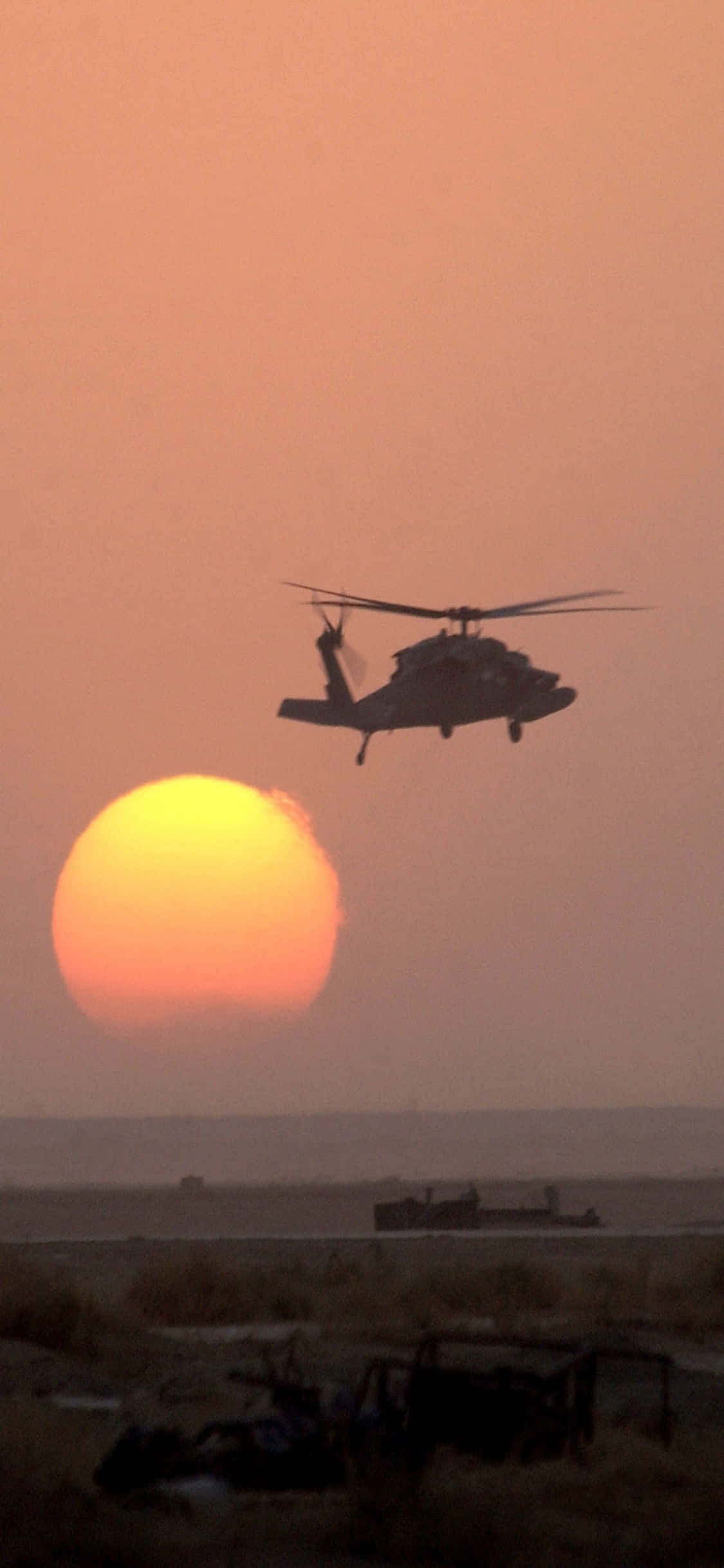 Mwonekano wa iPhone Xs na mwonekano wake katika dirisha la chopper Picha ya Ukuta