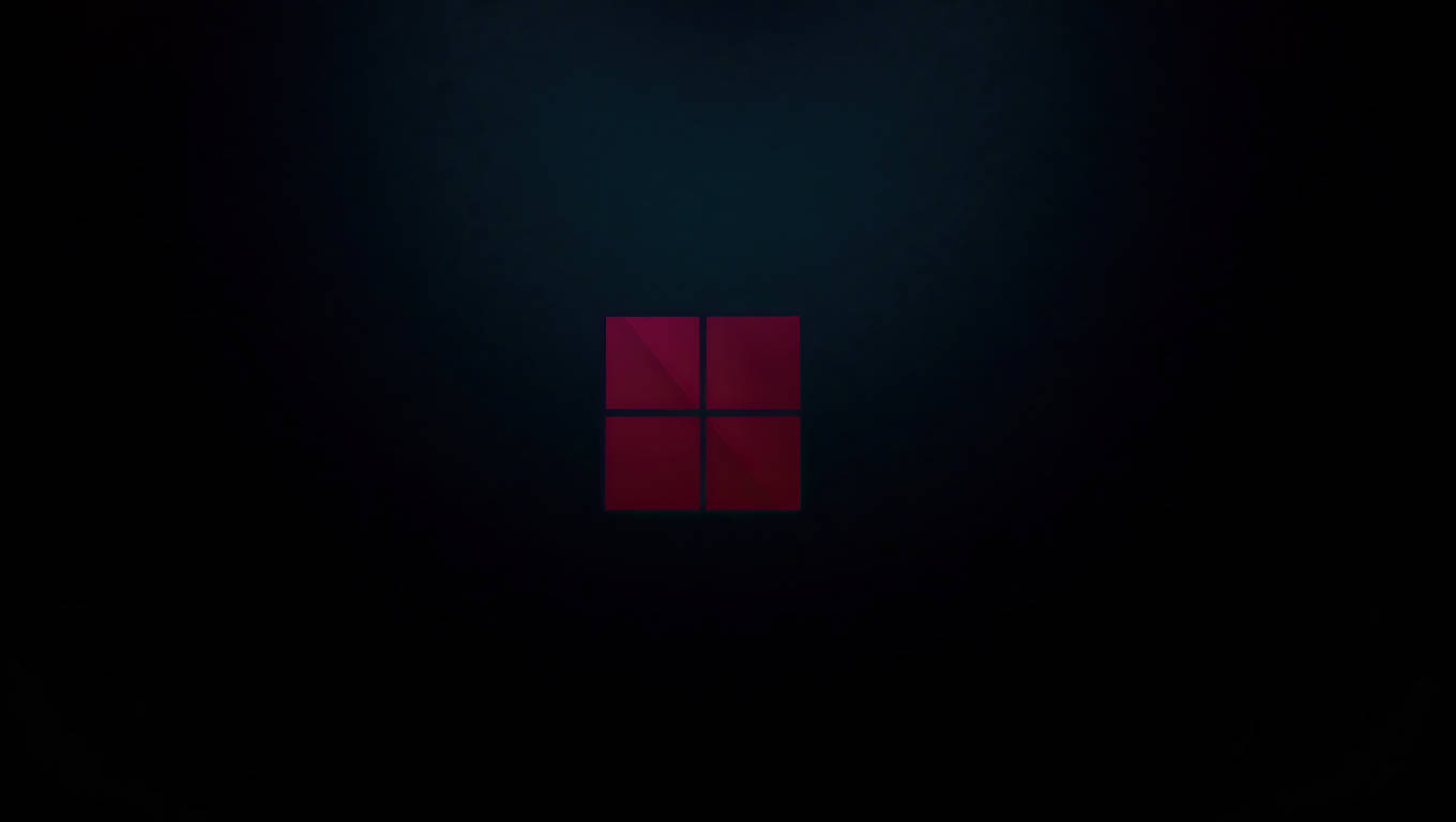 Nembo ya Windows 11 kwenye Laptop Nyeusi Picha ya Ukuta