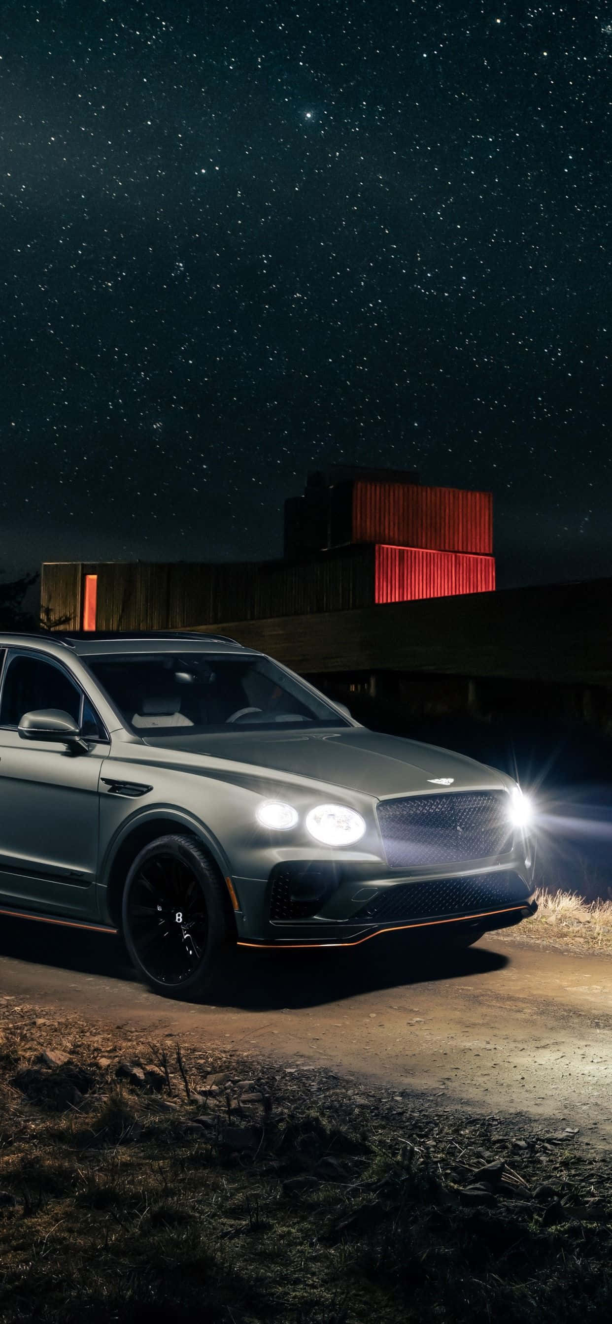 the new bentley bentayga is shown at night Picha ya Ukuta