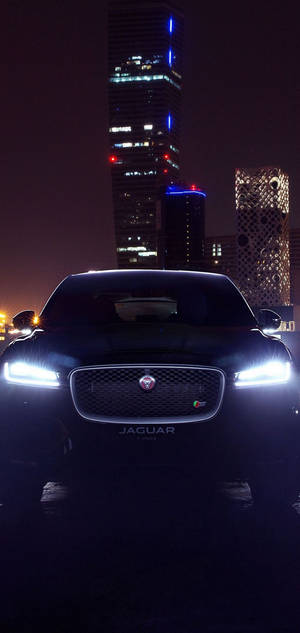 Black Jaguar car at night with headlights on wallpaper