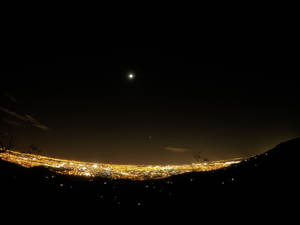 Radiant night city and clear sky wallpaper