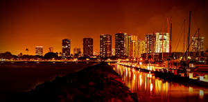 Glowing night city and water reflection wallpaper